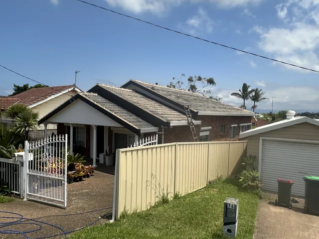 House with a faded, chalky, patchy grey tile roof, before restoration.